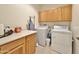 Laundry room with washer, dryer, cabinets, and counter space at 11100 W Magdalena Dr, Arizona City, AZ 85123