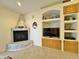 Cozy living room featuring a fireplace and built-in entertainment center at 11100 W Magdalena Dr, Arizona City, AZ 85123