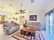 Living room featuring comfortable seating, a coffee table, and access to other areas at 11100 W Magdalena Dr, Arizona City, AZ 85123