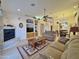 Spacious living room with a fireplace, neutral tones, and ample natural light at 11100 W Magdalena Dr, Arizona City, AZ 85123