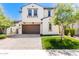 Two-story house with brown garage door and landscaped front yard at 12045 W Peak View Rd, Peoria, AZ 85383