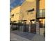 Front view of a townhome community with gated entry and landscaping at 1406 W Main St # 140, Mesa, AZ 85201