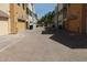 View of garages and a paved alleyway in a townhome community at 1406 W Main St # 140, Mesa, AZ 85201