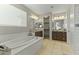 Elegant bathroom with double vanity and soaking tub at 14575 W Orange Dr, Litchfield Park, AZ 85340