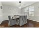 Bright dining room features hardwood floors and a charming wooden table with gray chairs at 14575 W Orange Dr, Litchfield Park, AZ 85340