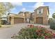 Two-story house with a three-car garage and landscaped front yard at 14575 W Orange Dr, Litchfield Park, AZ 85340