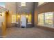Front entrance with a brick walkway, featuring a white door and warm lighting at 14575 W Orange Dr, Litchfield Park, AZ 85340