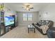 Game room with large TV, leather couch, and game console at 14575 W Orange Dr, Litchfield Park, AZ 85340