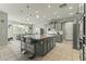Open kitchen features granite island and stainless steel appliances at 14575 W Orange Dr, Litchfield Park, AZ 85340