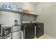 Well-equipped laundry room with washer, dryer, and ample shelving at 14575 W Orange Dr, Litchfield Park, AZ 85340