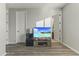 Living room with a flat-screen TV and wood flooring at 14575 W Orange Dr, Litchfield Park, AZ 85340