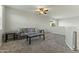 Spacious loft with couch and side tables, carpeted floor at 14575 W Orange Dr, Litchfield Park, AZ 85340