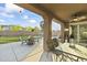 Covered patio with seating area overlooking backyard at 14575 W Orange Dr, Litchfield Park, AZ 85340