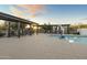 Community pool with lounge chairs and shaded seating at 14575 W Orange Dr, Litchfield Park, AZ 85340