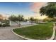 Community pool and grassy area at sunset at 14575 W Orange Dr, Litchfield Park, AZ 85340