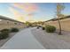 Curving concrete walkway through a landscaped area at 14575 W Orange Dr, Litchfield Park, AZ 85340