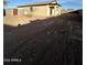 Large backyard with dirt and a small tree at 15494 S Kline Pl, Arizona City, AZ 85123