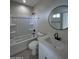 Clean bathroom with white vanity, tub, and black accents at 15494 S Kline Pl, Arizona City, AZ 85123