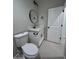 Modern bathroom with white vanity and a round mirror at 15494 S Kline Pl, Arizona City, AZ 85123