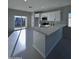 Modern kitchen with white cabinets, island, and stainless steel appliances at 15494 S Kline Pl, Arizona City, AZ 85123