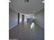 Open living room with tile floors and access to kitchen at 15494 S Kline Pl, Arizona City, AZ 85123