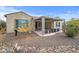 Landscaped backyard with covered patio and gravel at 18852 N 260Th Ln, Buckeye, AZ 85396