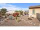 Landscaped backyard with desert plants and a pergola at 18852 N 260Th Ln, Buckeye, AZ 85396