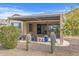 Backyard oasis with covered patio, cacti, and putting green at 18852 N 260Th Ln, Buckeye, AZ 85396