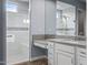 Spa-like bathroom with granite vanity, large shower, and white cabinets at 18852 N 260Th Ln, Buckeye, AZ 85396