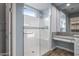 Bathroom with walk-in shower, granite vanity, and large mirror at 18852 N 260Th Ln, Buckeye, AZ 85396