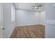 Spacious bedroom with wood-look flooring and ceiling fan at 18852 N 260Th Ln, Buckeye, AZ 85396