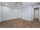 Spacious bedroom with wood-look flooring and ceiling fan at 18852 N 260Th Ln, Buckeye, AZ 85396