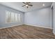 Well lit bedroom with wood-look floors and plantation shutters at 18852 N 260Th Ln, Buckeye, AZ 85396