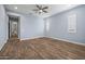 Spacious bedroom with wood-look floors, ceiling fan, and large windows at 18852 N 260Th Ln, Buckeye, AZ 85396
