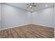 Spacious bedroom with wood-look flooring and ceiling fan at 18852 N 260Th Ln, Buckeye, AZ 85396