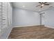 Bright bedroom with wood-look floors, plantation shutters, and a ceiling fan at 18852 N 260Th Ln, Buckeye, AZ 85396