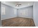 Bright bedroom featuring wood-look floors and plantation shutters at 18852 N 260Th Ln, Buckeye, AZ 85396