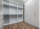 Bright walk-in closet with custom built-ins and drawers at 18852 N 260Th Ln, Buckeye, AZ 85396