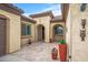 Courtyard with tile flooring, potted plants, and arched entryways leading into the home at 18852 N 260Th Ln, Buckeye, AZ 85396