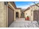 Front courtyard entry with tile flooring, potted plants, and arched entryways at 18852 N 260Th Ln, Buckeye, AZ 85396