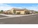 Corner lot home with tan stucco, tile roof, and mature desert landscaping at 18852 N 260Th Ln, Buckeye, AZ 85396