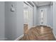 Home entry hallway with gray walls, herringbone flooring, and white doors at 18852 N 260Th Ln, Buckeye, AZ 85396