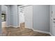 Modern hallway with wood-look floors and access to a spacious closet at 18852 N 260Th Ln, Buckeye, AZ 85396