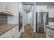 Clean and bright hallway with hardwood floors and storage at 18852 N 260Th Ln, Buckeye, AZ 85396