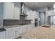 Modern kitchen with white cabinets and granite countertops at 18852 N 260Th Ln, Buckeye, AZ 85396