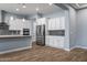 Modern kitchen with white cabinets and stainless steel appliances at 18852 N 260Th Ln, Buckeye, AZ 85396