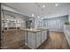 Open concept kitchen with views into living room and fireplace at 18852 N 260Th Ln, Buckeye, AZ 85396