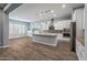 Modern kitchen with white cabinets and granite island at 18852 N 260Th Ln, Buckeye, AZ 85396