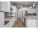 Modern kitchen with white cabinets, granite counters, and stainless steel appliances at 18852 N 260Th Ln, Buckeye, AZ 85396