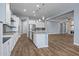 Open kitchen with white cabinets and granite countertops at 18852 N 260Th Ln, Buckeye, AZ 85396